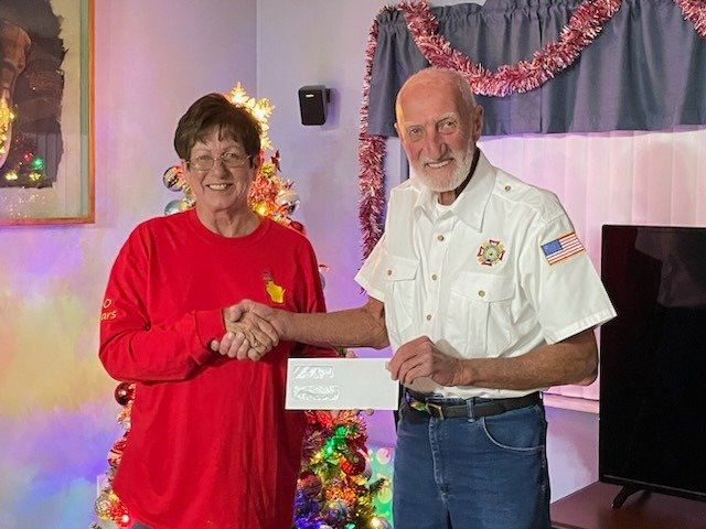 Pictured are Juanita Wright on behalf of Queen Bee Farms and Junior Vice Commander Gary Baily.